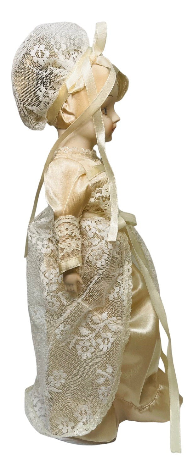 PORCELAIN DOLL 14" WEARING CREAM LACE SATIN GOWN W/MATCHING LACE BONNET.