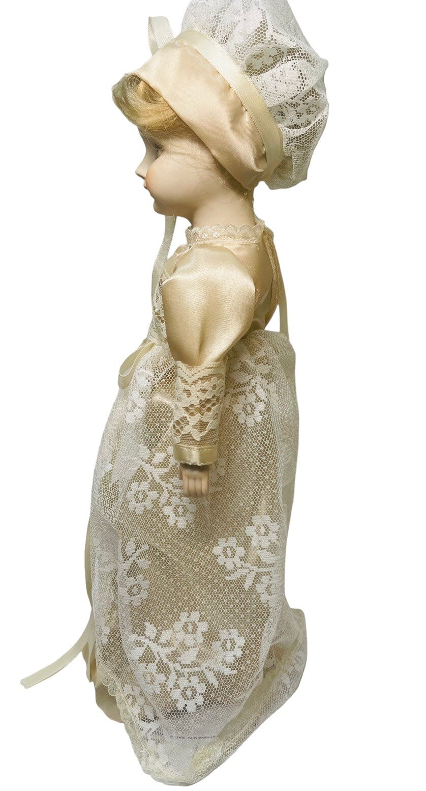 PORCELAIN DOLL 14" WEARING CREAM LACE SATIN GOWN W/MATCHING LACE BONNET.