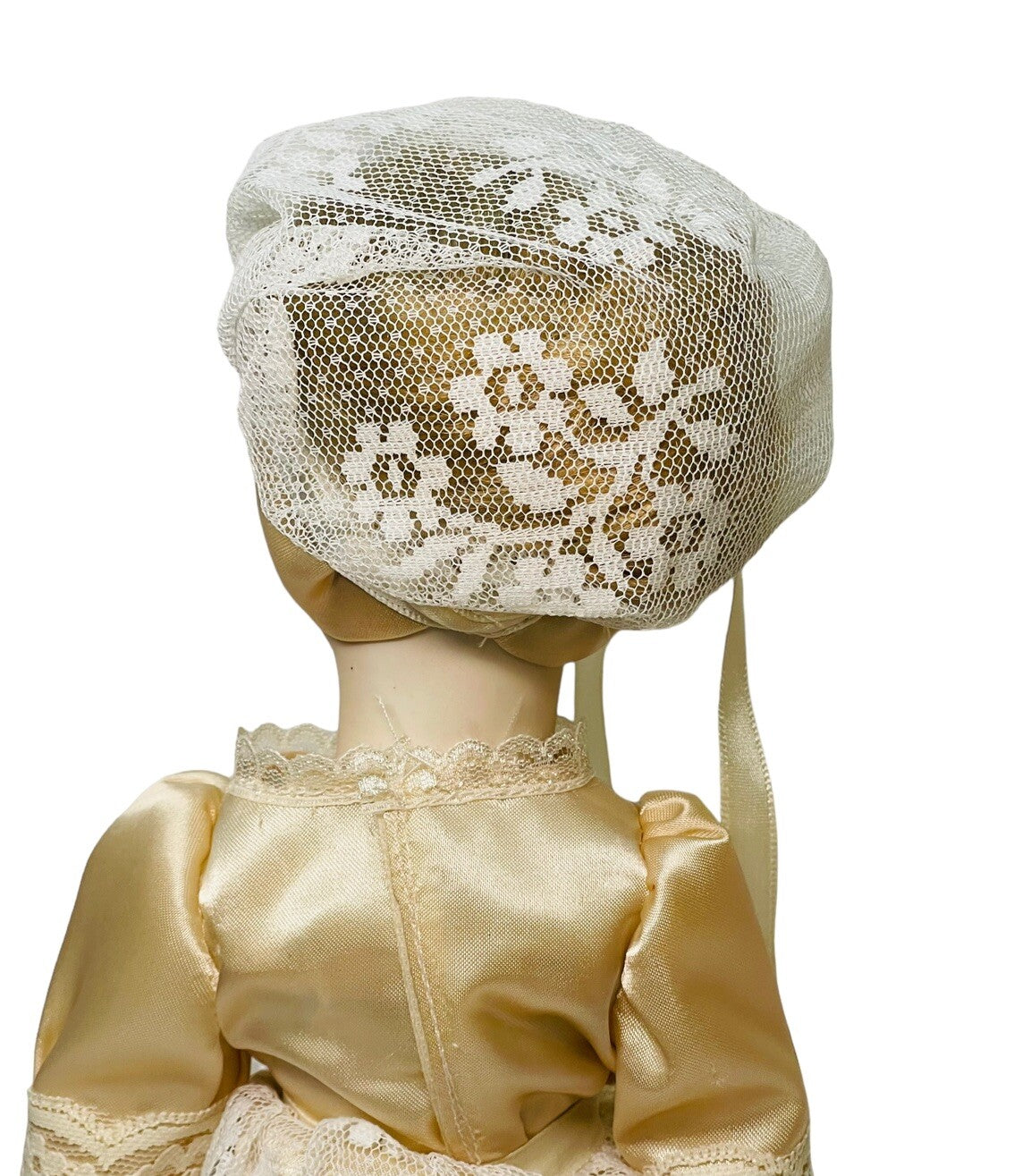 PORCELAIN DOLL 14" WEARING CREAM LACE SATIN GOWN W/MATCHING LACE BONNET.