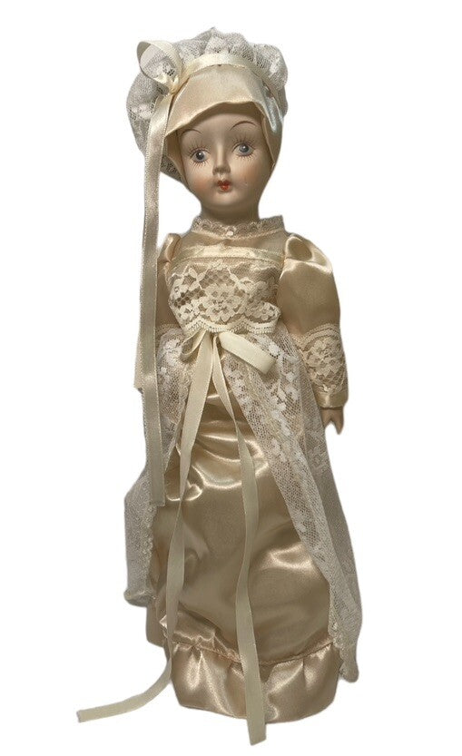 PORCELAIN DOLL 14" WEARING CREAM LACE SATIN GOWN W/MATCHING LACE BONNET.